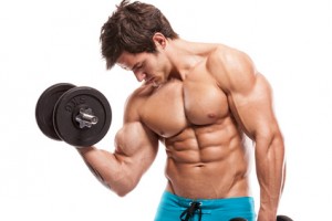 Muscular bodybuilder guy doing exercises with dumbbells over whi